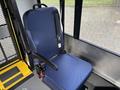 A blue upholstered driver's seat with a seatbelt set in a vehicle interior designed for a 2021 Ford Transit-350