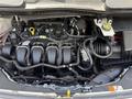 A 2021 Ford Transit Connect engine with various components visible including the intake manifold oil dipstick and electrical connections