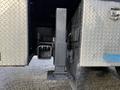 A close-up of the hitch mechanism on a 2010 International 4300 truck with a metal frame and latch components