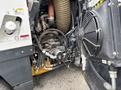 Close-up view of the engine compartment of a 2019 Madvac LS175 showing various hoses and components including a fan and a large vacuum hose