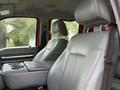 Interior view of a 2013 Ford F-550 with gray leather seats and a center console with storage space