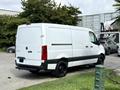 A white 2021 Mercedes-Benz Sprinter van parked with a sliding side door closed and black wheels
