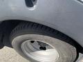 A close-up view of a rear tire of a 2020 Chevrolet Express showing the tire tread and metal rim