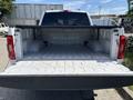 A 2021 Ford F-150 with an open truck bed showing a clean and empty storage area without any cargo inside
