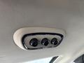 Three control knobs mounted on a beige ceiling trim in a 2015 Dodge Durango for adjusting vehicle settings