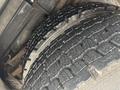 Close-up view of a heavy-duty tire tread showcasing deep grooves and rugged texture designed for traction and stability on a 2006 E-One Typhoon vehicle