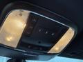 Interior overhead console of a 2019 Jeep Grand Cherokee featuring buttons for lights and ventilation