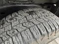 A close-up of a tire on a 2012 GMC Canyon showing the detailed tread pattern with mud and dirt on its surface