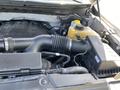 Close-up view of the engine bay of a 2014 Ford F-150 showing the air intake system and other components