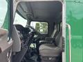 Interior view of a 2013 Kenworth T370 truck showing the driver's seat steering wheel and dashboard controls