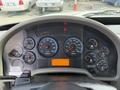 Dashboard of a 2011 International 4300 featuring a speedometer tachometer fuel gauge and various warning lights