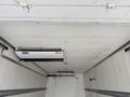 A 2019 Ford F-750 truck with a refrigerated cargo area featuring two air conditioning units mounted on the ceiling