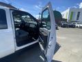 A white 2016 Ford F-350 SD with an open driver's side door showcasing the interior and seating area