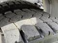 Close-up of a heavily treaded tire from a 2016 Freightliner 108SD showing wear and dirt on the surface