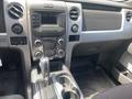 Interior view of a 2014 Ford F-150 showcasing the dashboard center console gear shifter and control panel