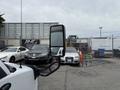A 2020 Chevrolet Express van with a side mirror prominently displayed in the foreground