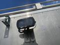 A Trilliant LED work light mounted on the side of a silver cargo truck with a metallic finish
