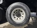 Close-up of a Michelin tire mounted on a 2008 Kenworth T370 featuring a steel rim and multiple lug nuts
