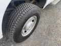 A close-up of a tire on a 2014 Ford F-350 SD showing a rugged tread pattern and a silver wheel rim