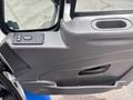 Door interior of a 2013 International DuraStar 4300 featuring a gray panel with controls and a handle