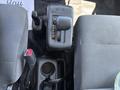 The interior of a 2020 Hino 338 showing the gear shift lever and the gear selector with positions for park reverse neutral drive and low gear