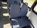 A pair of blue upholstered seats in a 2017 Chevrolet Express with seat belts and no visible passengers