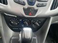 Dashboard controls of a 2017 Ford Transit Connect with air conditioning knobs gear shifter and hazard light button