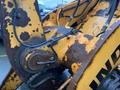 A close-up view of a rusted and worn section of a 2016 Hyundai HL940 wheel loader with visible hydraulic hoses and yellow paint peeling off the metal surface