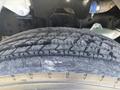 Close-up of a tire from a 2022 Freightliner M2 106 showing tread patterns and surface details