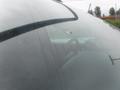 A 2015 Chevrolet Silverado 1500 with a damaged windshield showing a noticeable hole in the glass and some dirt on the surface