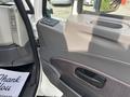 Interior view of a 2013 International WorkStar door panel featuring controls and a beverage holder