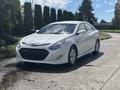 A 2014 Hyundai Sonata in white with a sleek design featuring a distinctive front grille and modern headlights parked on a driveway