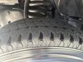 Close-up of a tire from a 2012 Ford E-450 showing detailed tread patterns and a shiny rim