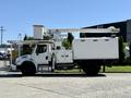 A 2010 Freightliner M2 106 bucket truck with a white body features an extendable boom and is equipped for utility work