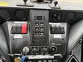 Dashboard of a 2017 Autocar Xpert showing buttons for air horn city horn mode and ignition with keys in the ignition and a display panel above