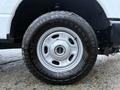 White wheel of a 2023 Ford F-250 with a Firestone tire designed for heavy-duty performance