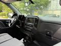Interior view of a 2018 Chevrolet Silverado 1500 featuring a dashboard with a touchscreen display and control buttons along with seating and steering wheel