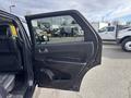 A black 2015 Dodge Durango with an open driver's side door showing the interior features and controls