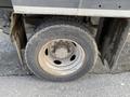 A close-up of a rear wheel and tire of a 2009 Dodge Ram 5500 showing a silver rim with visible dirt on the tire surface and tread