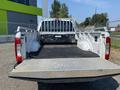 A 2017 Ford F-250 SD with an open truck bed featuring a rubber mat and a metal diamond plate tailgate