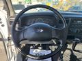 Steering wheel and dashboard of a 2004 Ford F-750 displaying gauges and control knobs