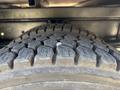 Close-up of a rugged tire tread on a 2005 GMC C7500 Topkick showcasing deep grooves and textured surface