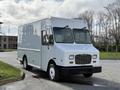 A white 2017 Freightliner MT45 delivery truck with a flat front and large windows parked at an angle