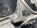The dashboard of a 2019 Ford Transit featuring a speedometer and various controls on the steering wheel