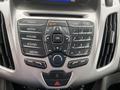 The image shows the dashboard controls of a 2017 Ford Transit Connect featuring a radio and media control panel with various buttons and a digital display