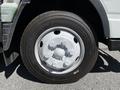 Wheel of a 2013 Mitsubishi Fuso FE160 with a silver rim and black tire showing tread pattern