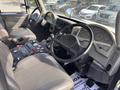 Interior view of a 2012 International DuraStar 4300 featuring a steering wheel dashboard with gauges and controls seats are upholstered in grey leather