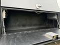 A 2016 Ford F-550 Super Duty work truck with an open utility bed showing storage compartments and a lockable box