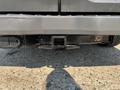 A rear view of a 2016 Ford Transit 150 showing the hitch receiver and wiring harness attachment point
