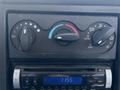Dashboard controls of a 2008 International DuraStar featuring temperature and airflow knobs along with a Pioneer car stereo display showing the time